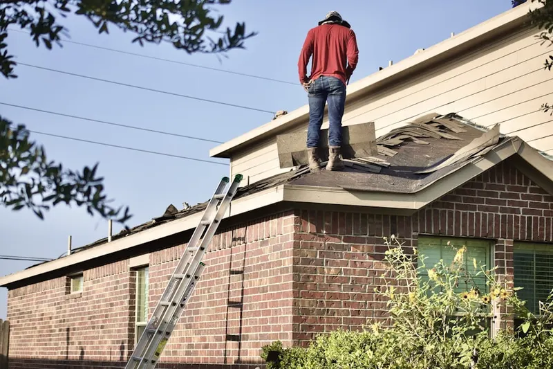 Professional roofer working on a residential roof in West Oaks Village